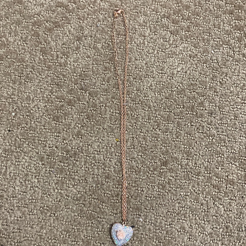 Heart shaped locket with a pink rose